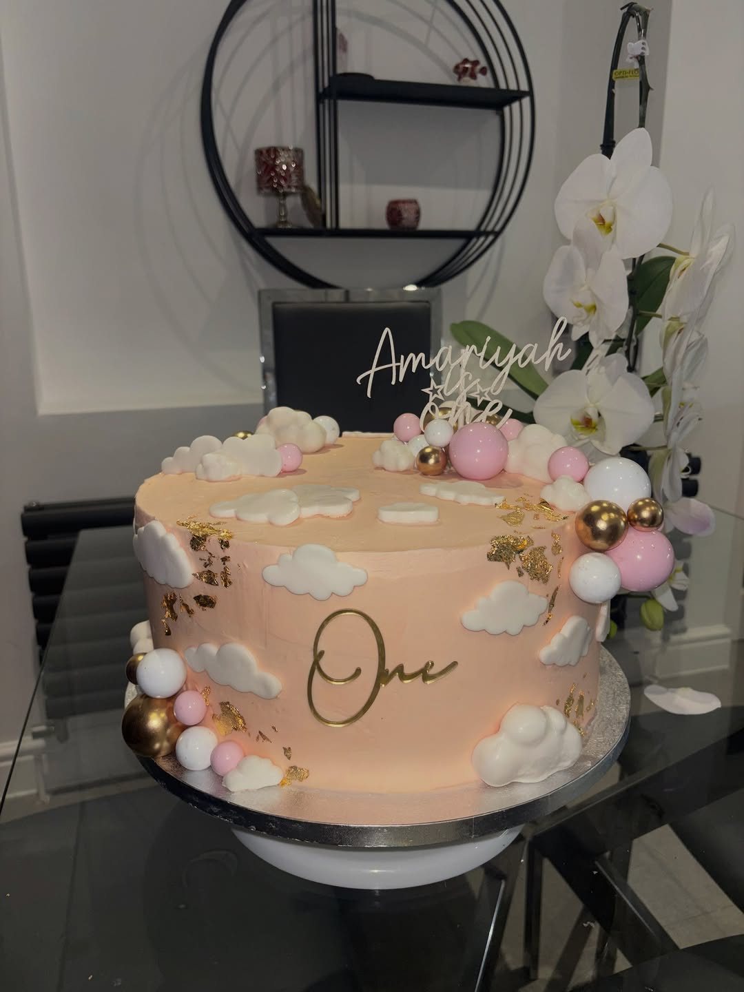 Pink first birthday cake with clouds, gold leaf and balloon detailing by Cakes by Leila